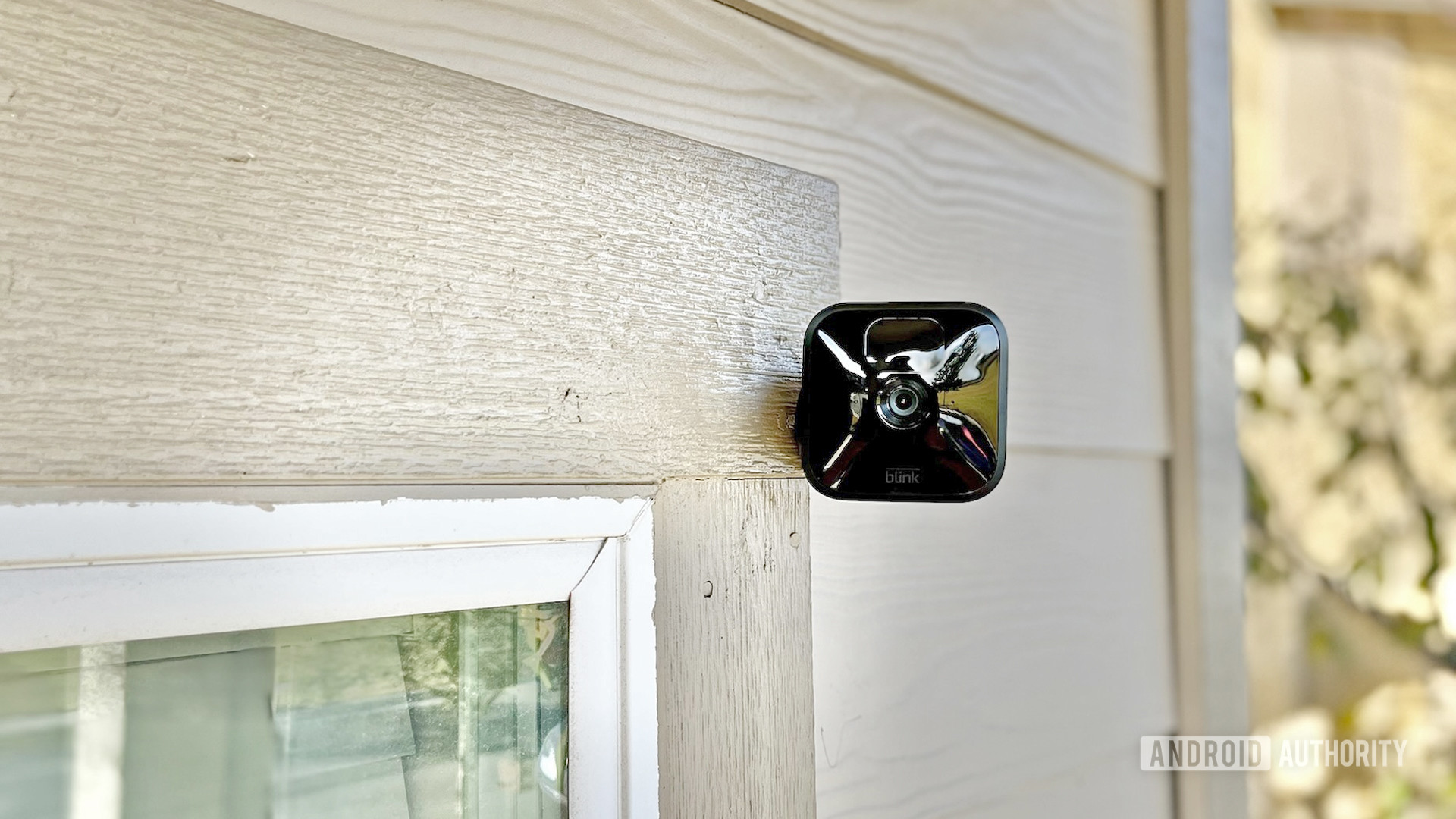 The Blink Outdoor camera perched outside a house