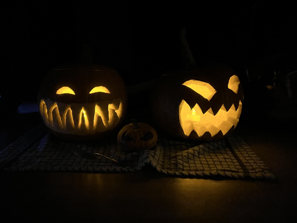 Camera sample dark shot of two carved pumpkins with candles inside on the Apple iPhone 13 Pro Max