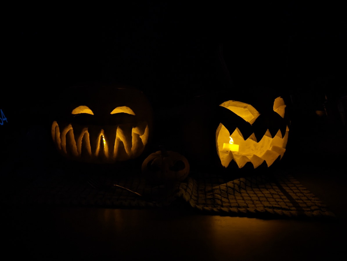 Camera sample dark shot of two carved pumpkins with candles inside on the Google Pixel 6 Pro