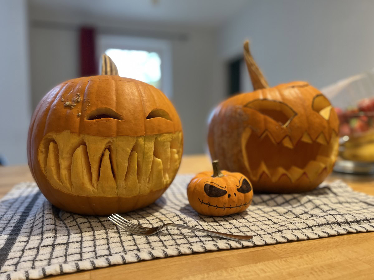 Camera sample portrait of two large and one small carved pumpkins, taken on the Apple iPhone 13 Pro Max