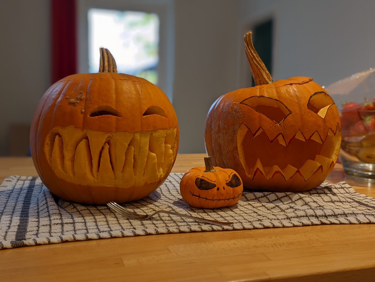 Camera sample portrait of two large and one small carved pumpkins taken on the Google Pixel 6 Pro