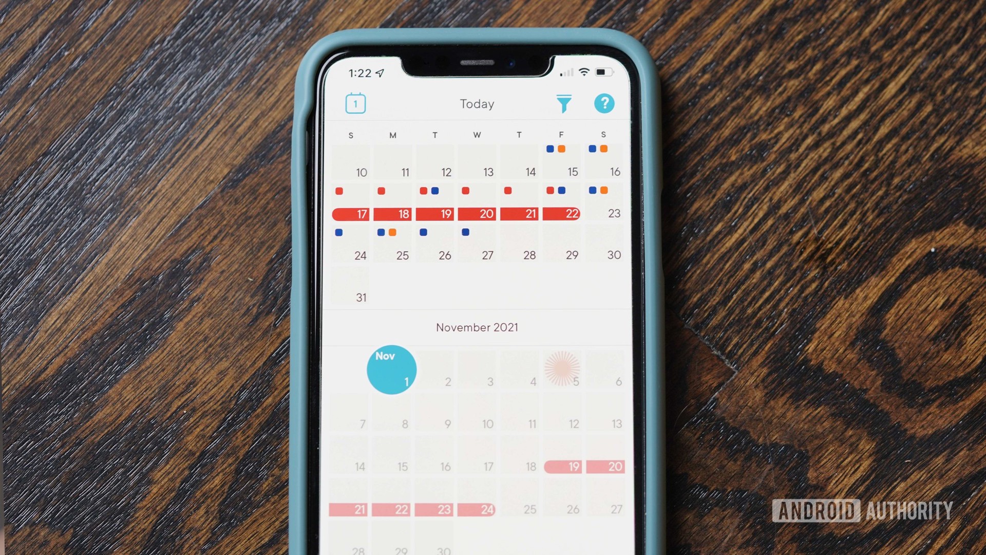 An iPhone 11 displays the Calendar tab in the Clue app.