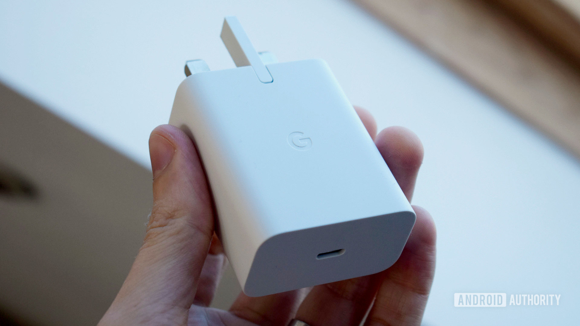 Google 30W USB C Power Adapter held held in hand by window