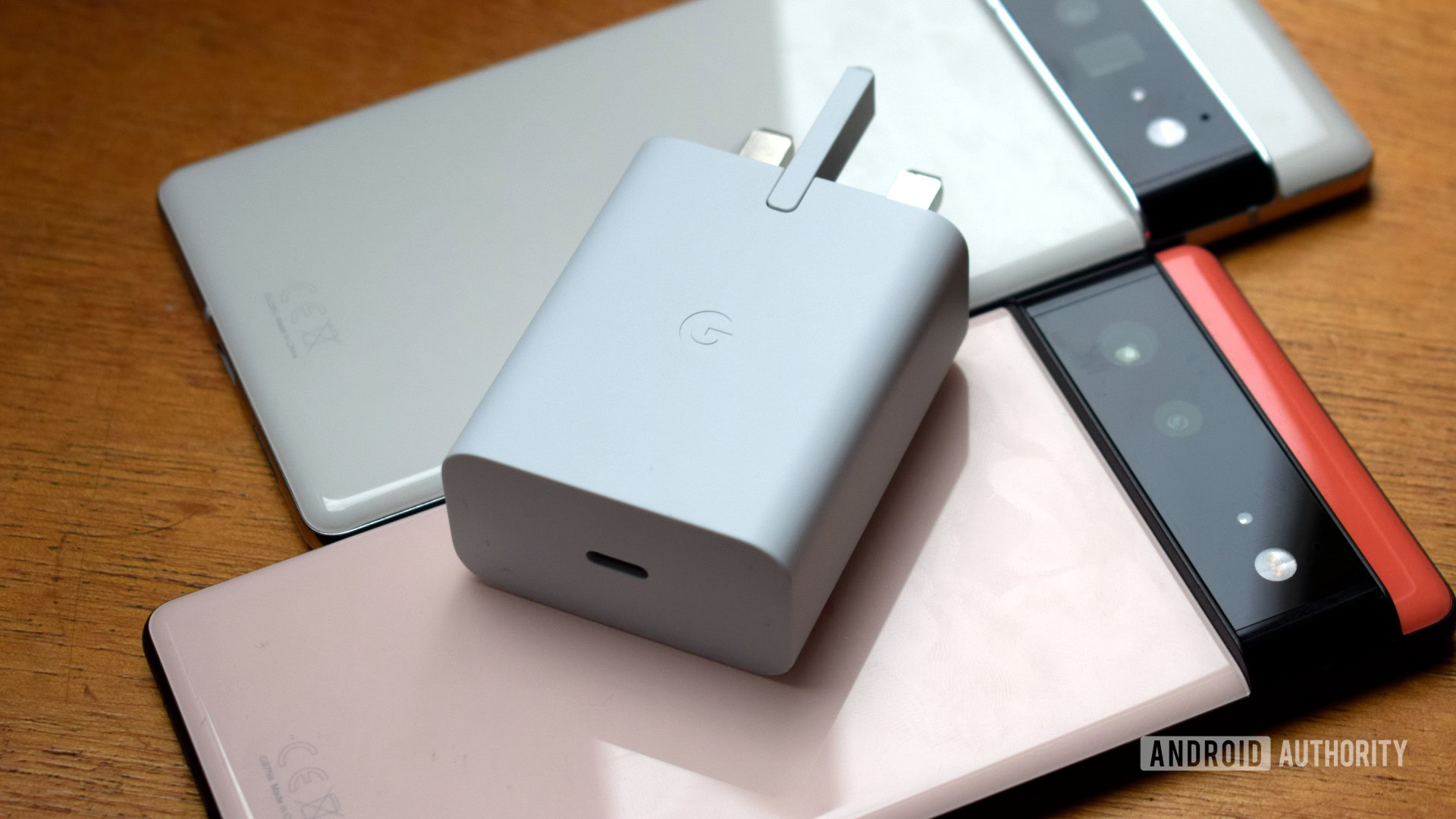 Google 30W USB C Power Charger resting on Google Pixel 6 and 6 Pro