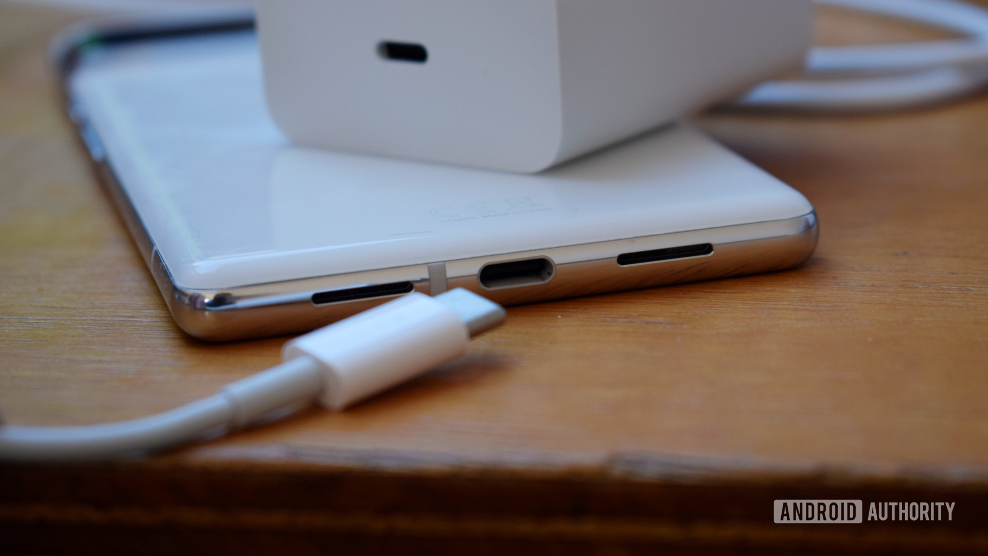 Google Pixel 6 Pro face down on desk next to USB-C charging cable