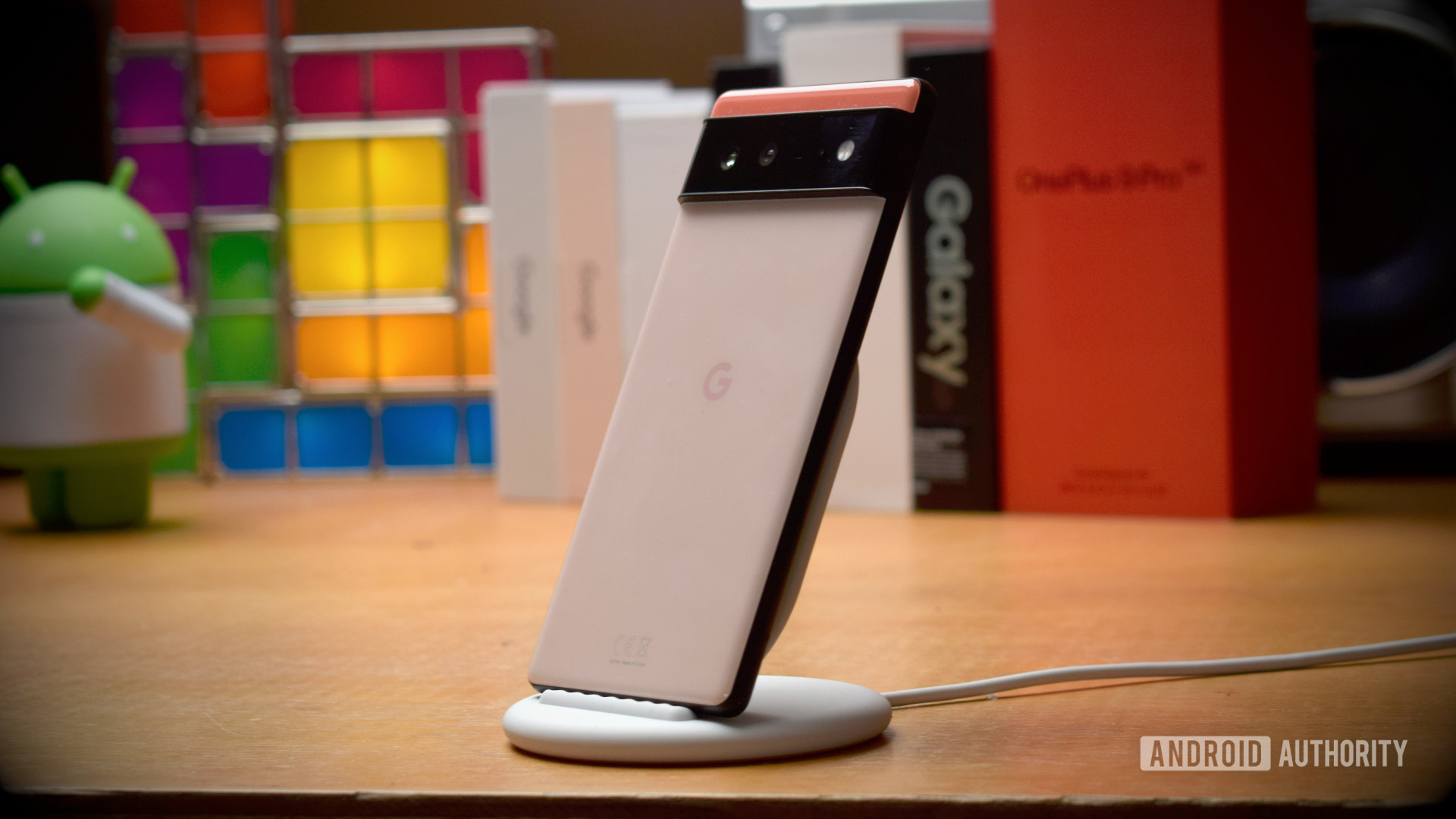 Google Pixel 6 on Pixel Stand with phones in background