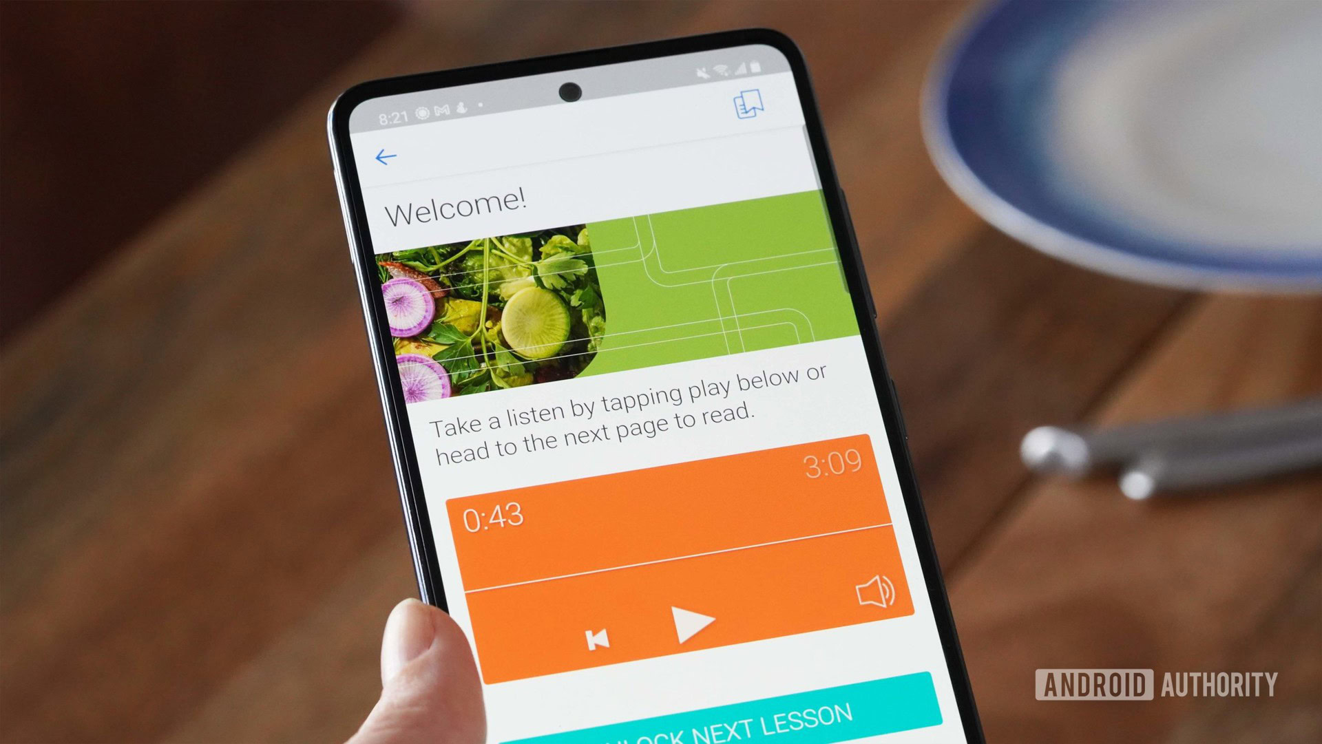 A user at the dinner table accesses a lesson in the app on their Samsung Galaxy A51.