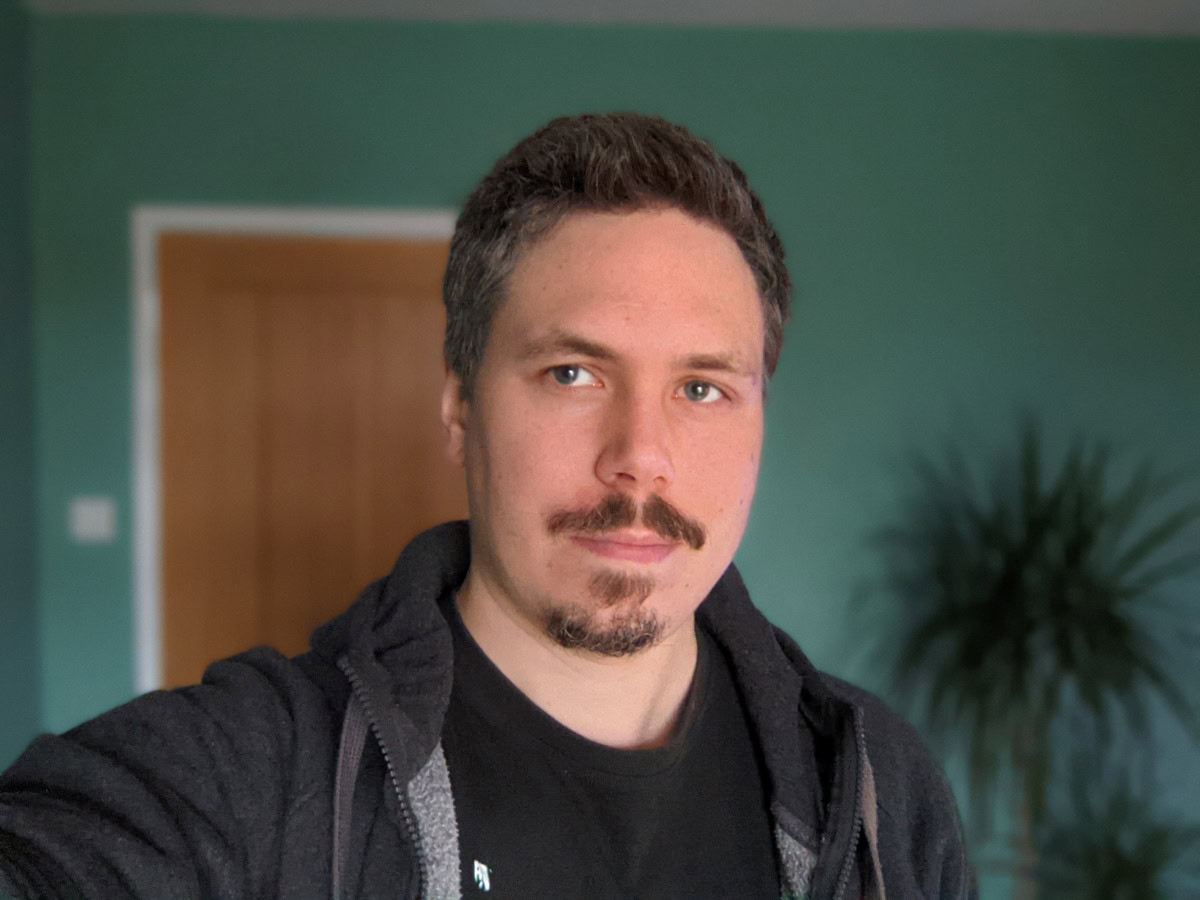 Pixel 5 selfie indoors of man with green walls in background