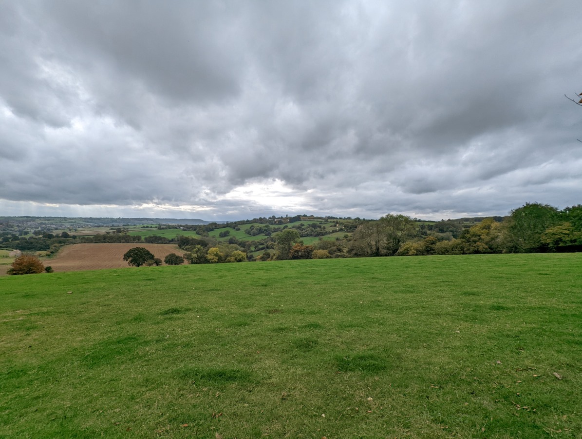 Wide angle picture of a grassy valley and overcast sky shot on Google Pixel 6 Pro