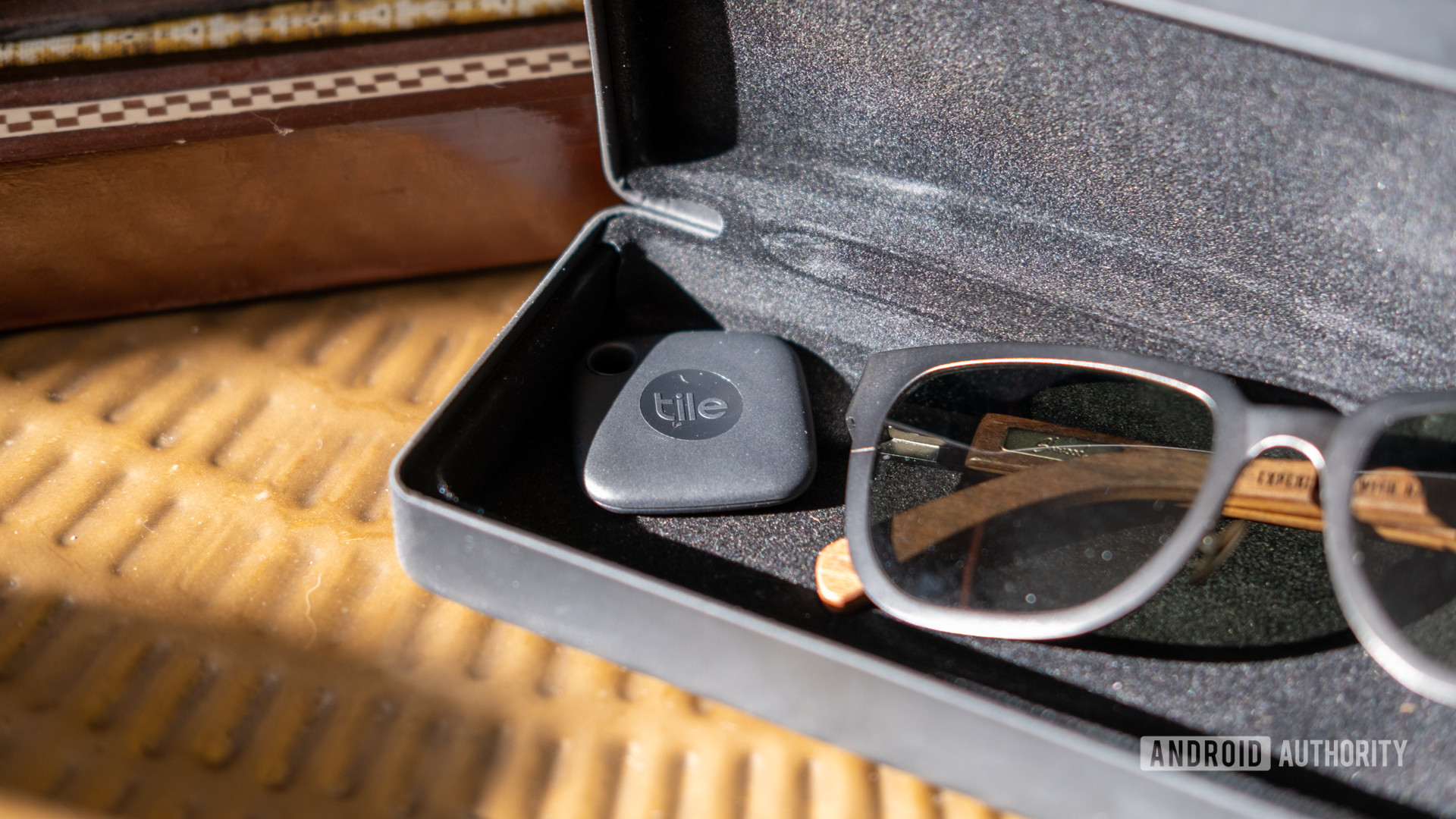 The black Tile Mate in a sunglasses case