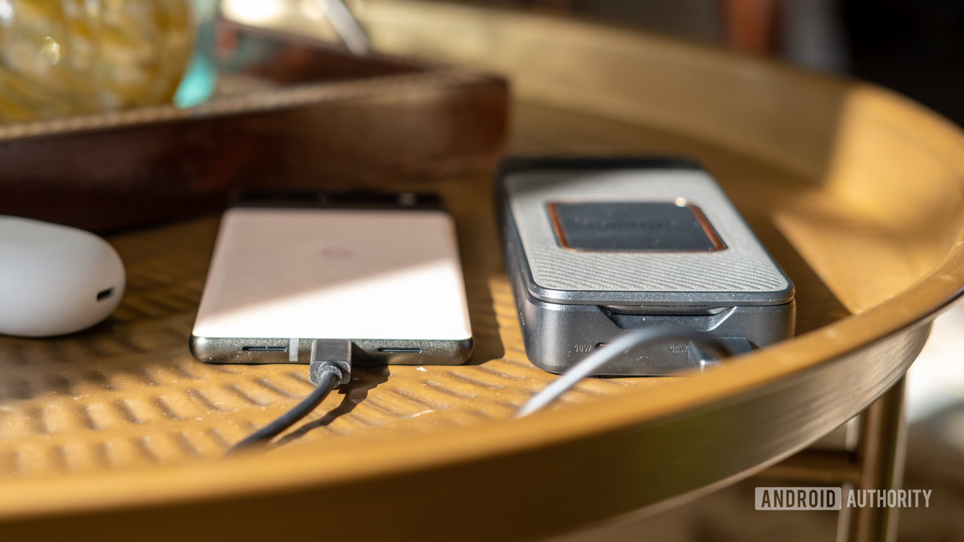 Otterbox Folding Wireless Power Bank on table showing thickness vs Pixel 6