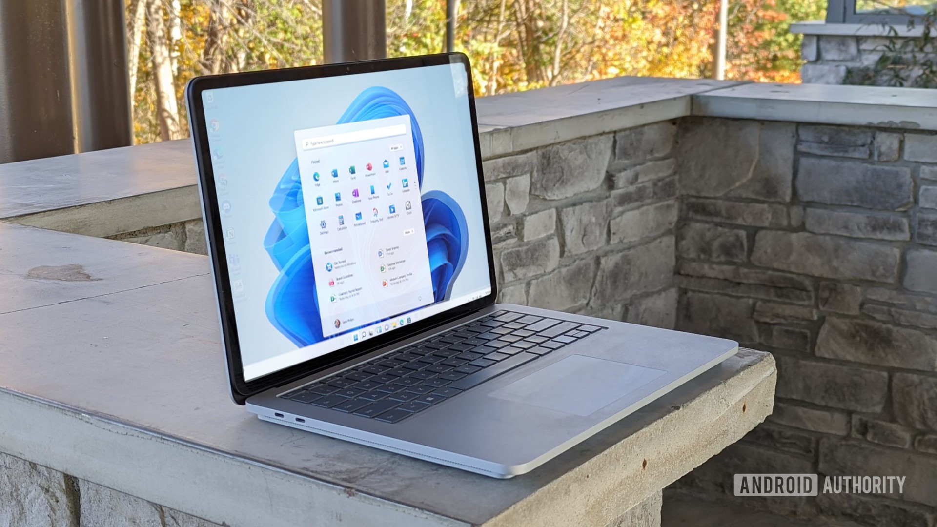 Surface Laptop Studio on a wall outdoors, showing the screen.