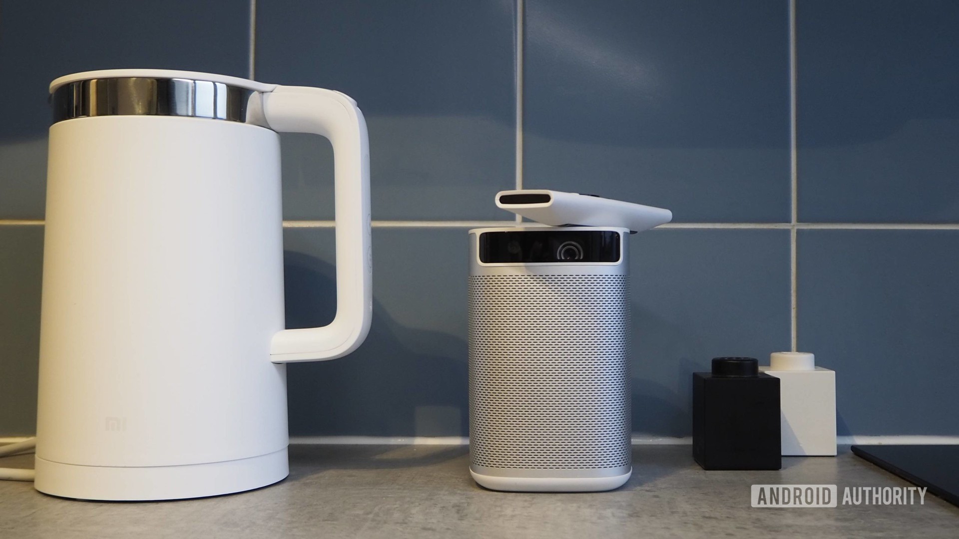 Xgimi Mogo Pro Android TV projector on kitchen counter next to Xiaomi smart kettle