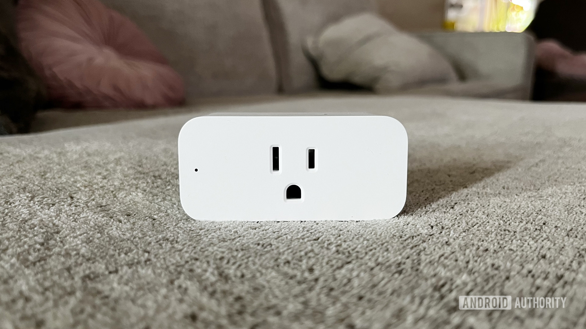 A beauty shot of the Amazon Smart Plug on a couch