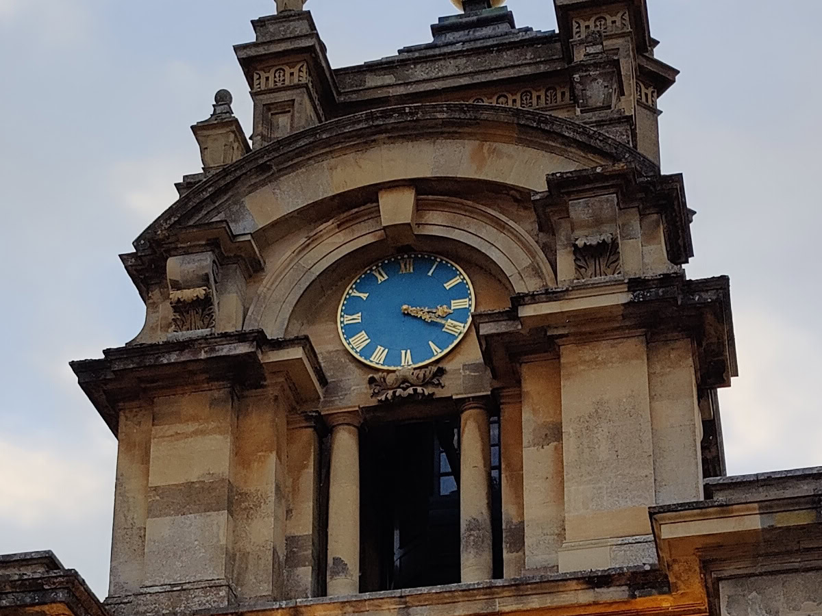 Crop of stone clock tower with blue clock shot on OnePlus 9 Pro
