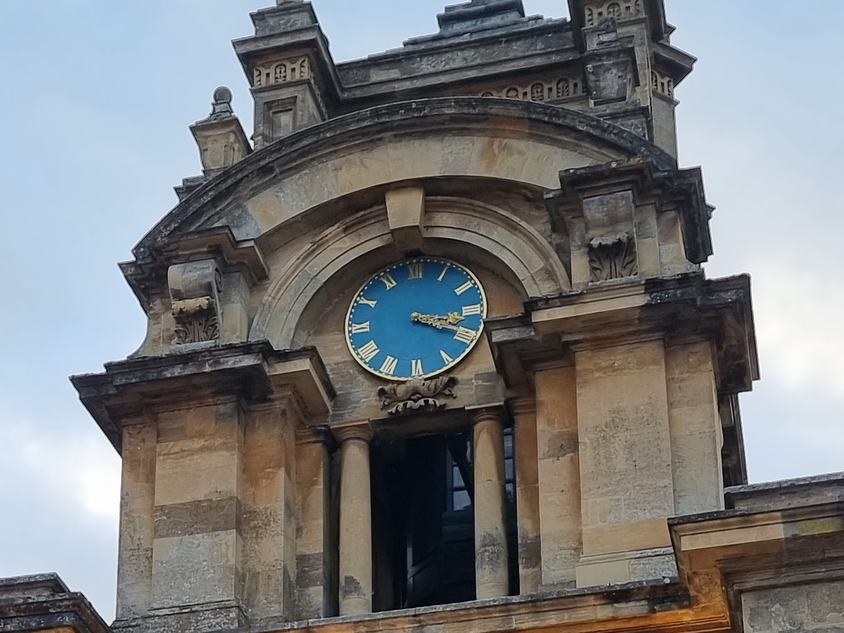 Crop of stone clock tower with blue clock shot on Samsung Galaxy S21 Ultra