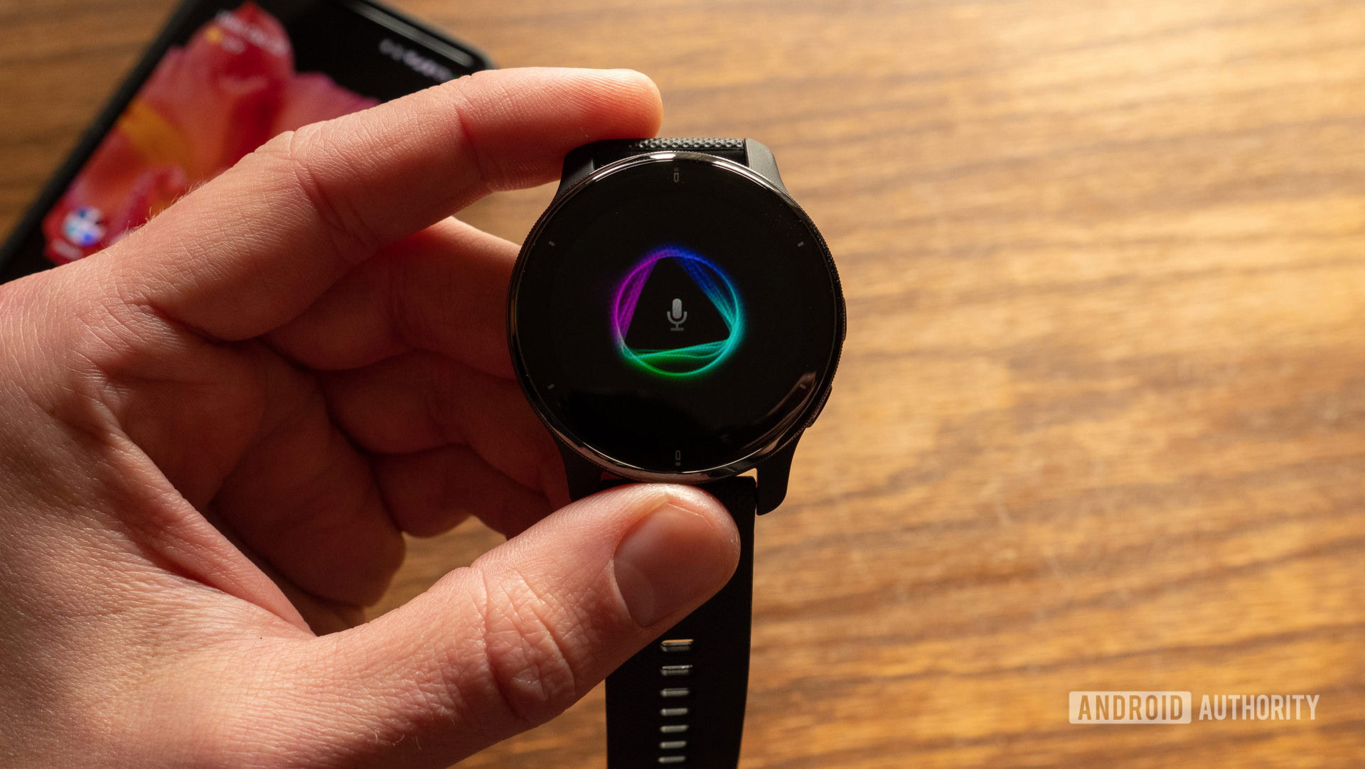 An image of the Garmin Venu 2 Plus in hand showing the voice assistant animation