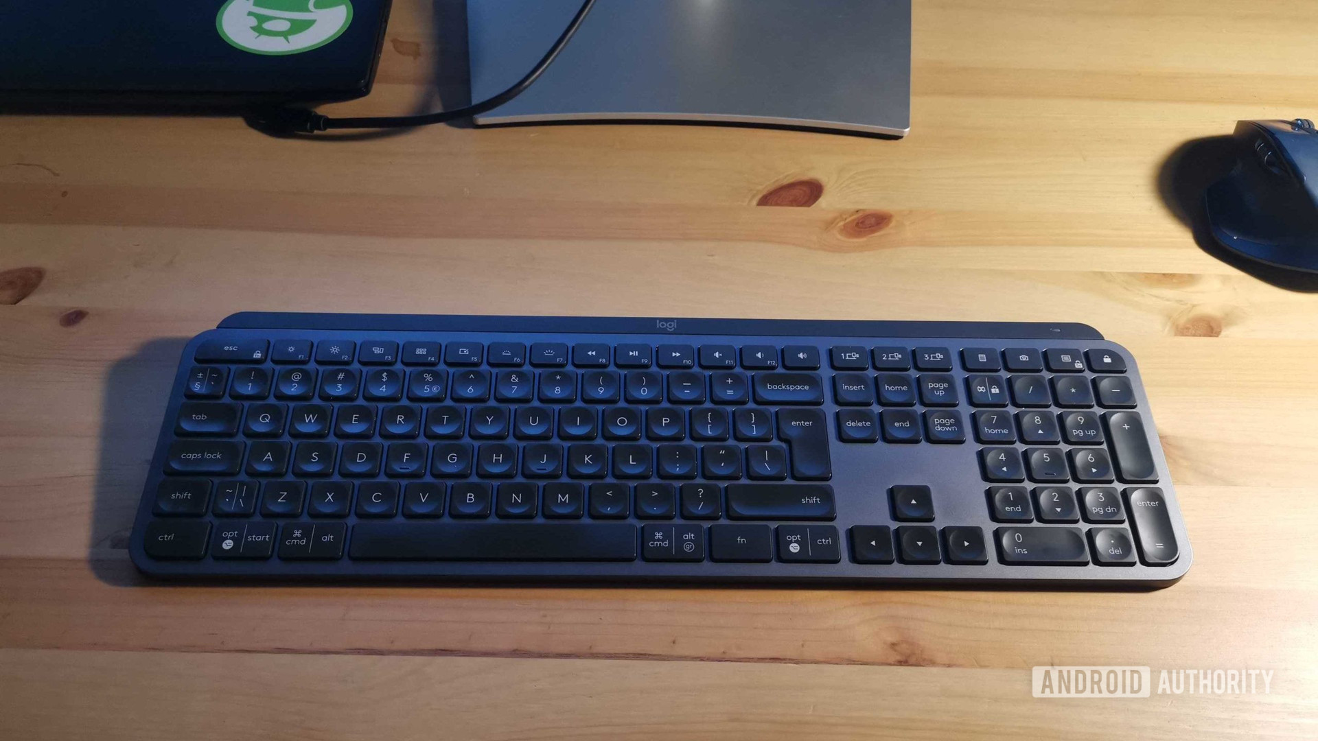 Logitech mx keys keyboard on a wooden desk