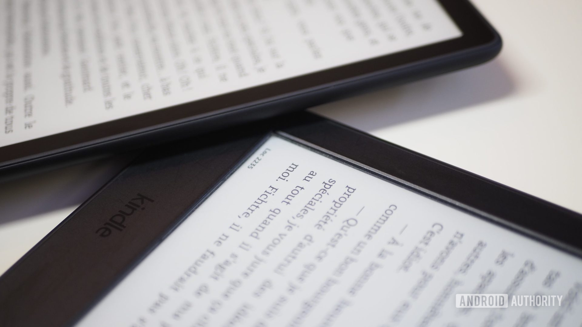Amazon Kindle Paperwhite 2021 next to Paperwhite 2015, focus on flat vs recessed display