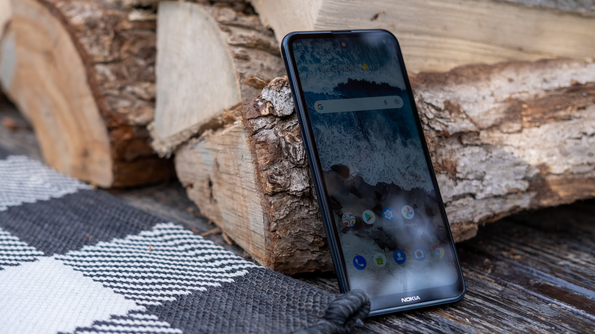 nokia x100 leaning on wood