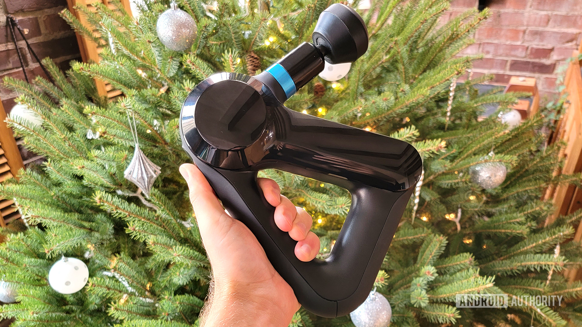 theragun elite massage gun in front of a christmas tree