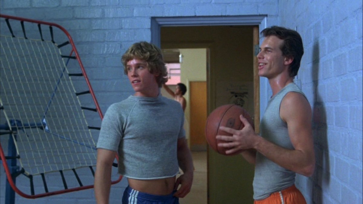 Two boys, one holding a basketball, in a school gym in Butcher, Baker, Nightmare Maker