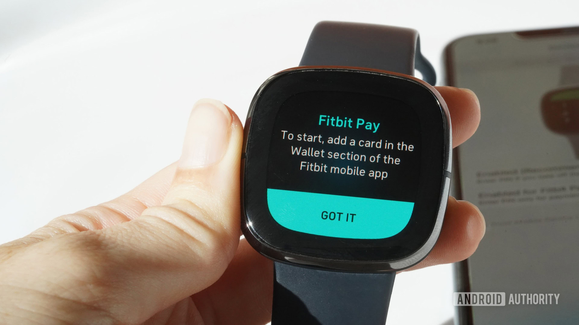 A Fitbit Sense users follows on-screen instructions for setting up Fitbit Pay.