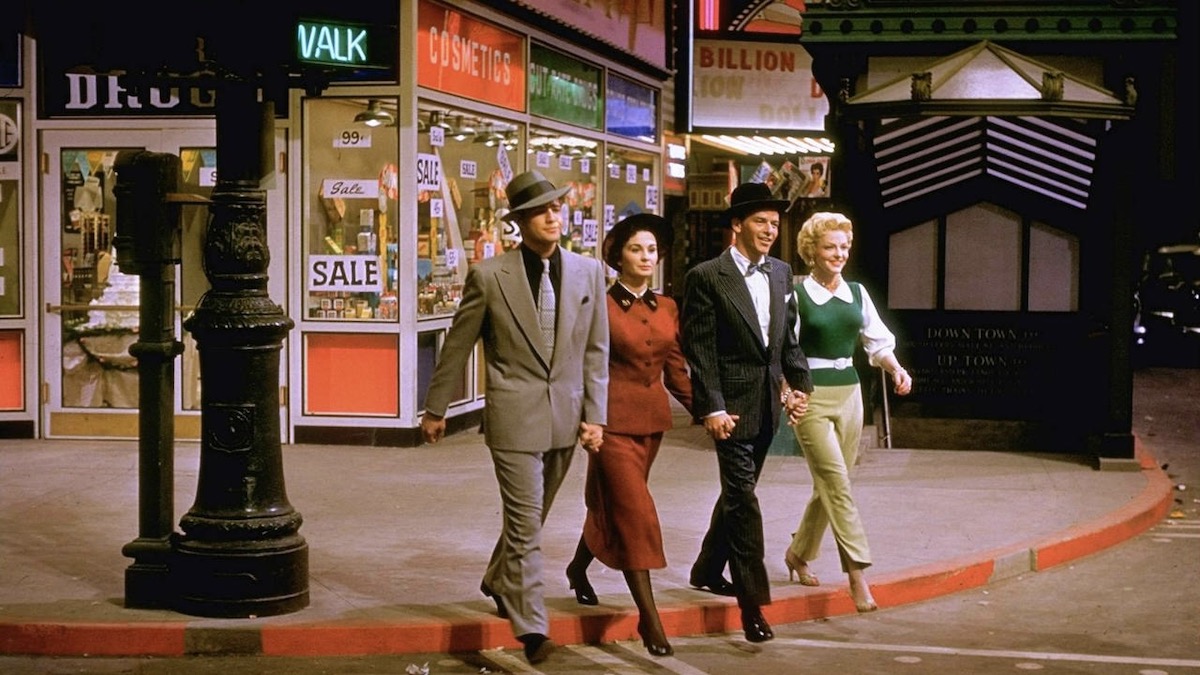 Marlon Brando, Jean Simmons, Frank Sinatra, and Vivian Blaine walk down the street, arm in arm, in Guys and Dolls best classic movies on amazon prime video
