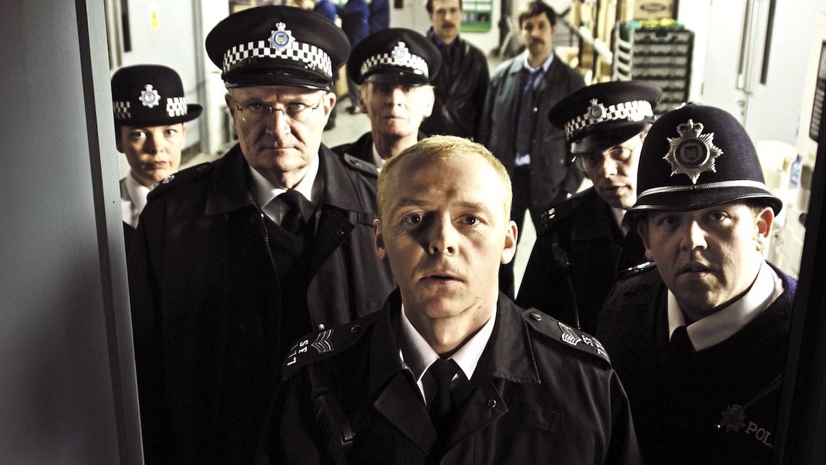 Simon Pegg, Nick Frost, and Jim Broadbent as cops, with backup, in Hot Fuzz - best movies on peacock