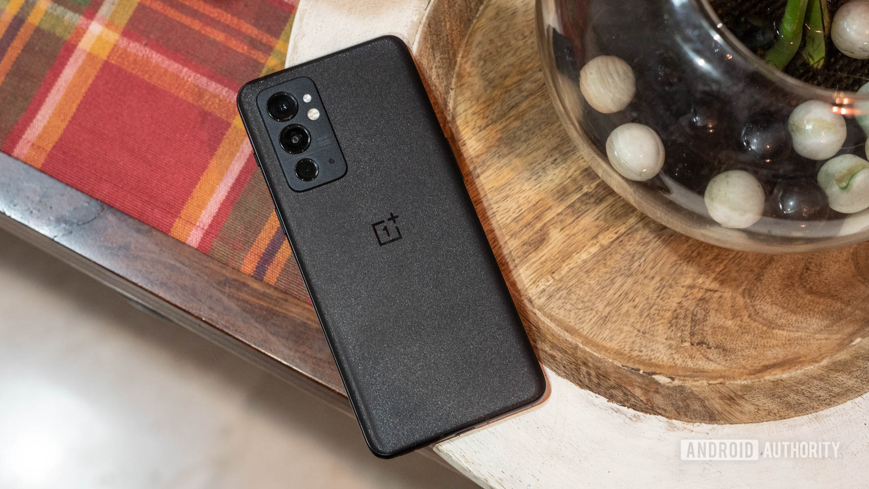 OnePlus 9RT rear panel gleaming under direct light