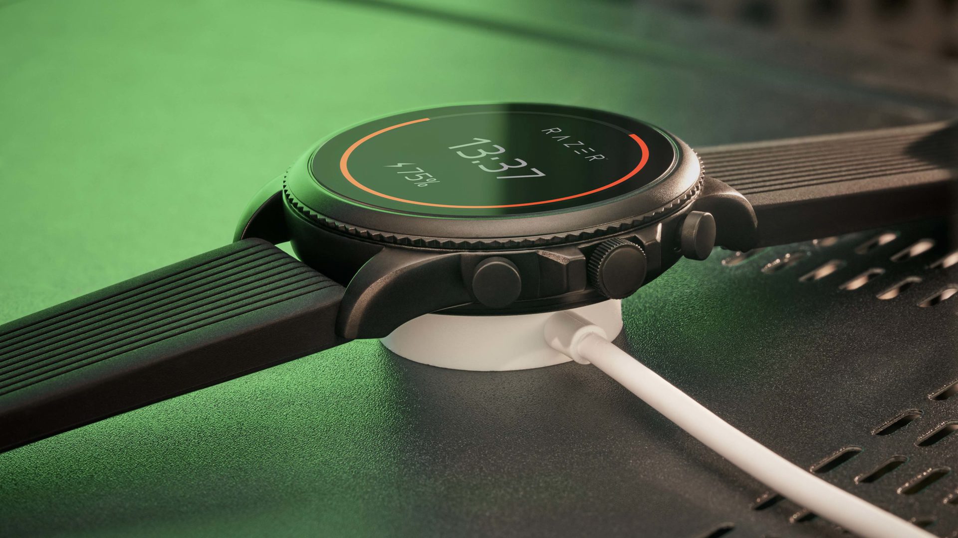 A Razer X Fossil Gen 6 rests on its charger and displays a battery life at 75%.