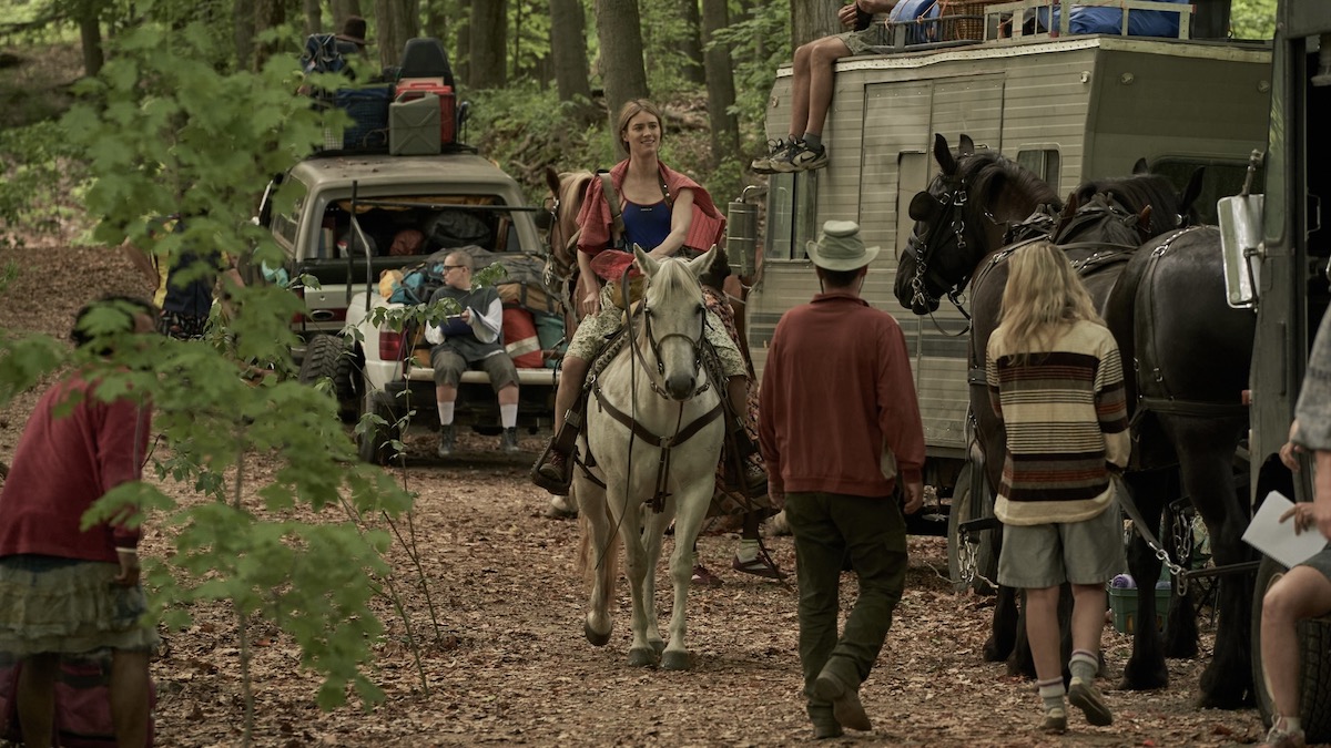 Mackenzie Davis rides a horse among her traveling theater group as Kirsten in Station Eleven — BEST ORIGINAL STREAMING SHOW