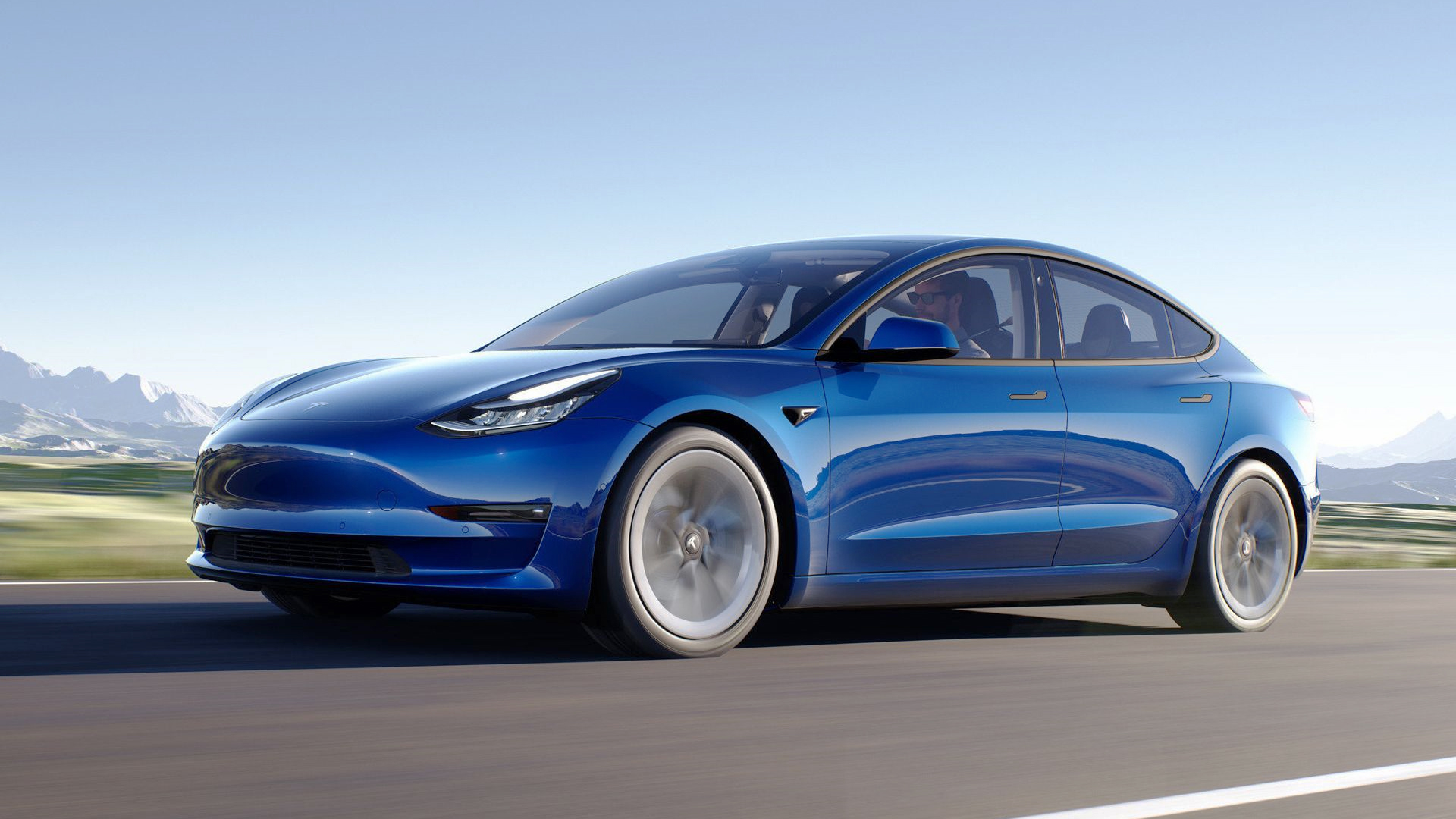 A blue Tesla Model 3 On Road
