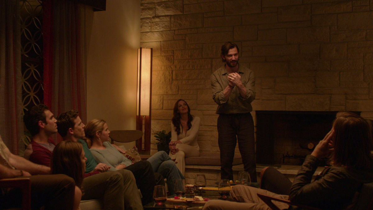 A group gathered in a living room during a party in The Invitation — best movies on shudder