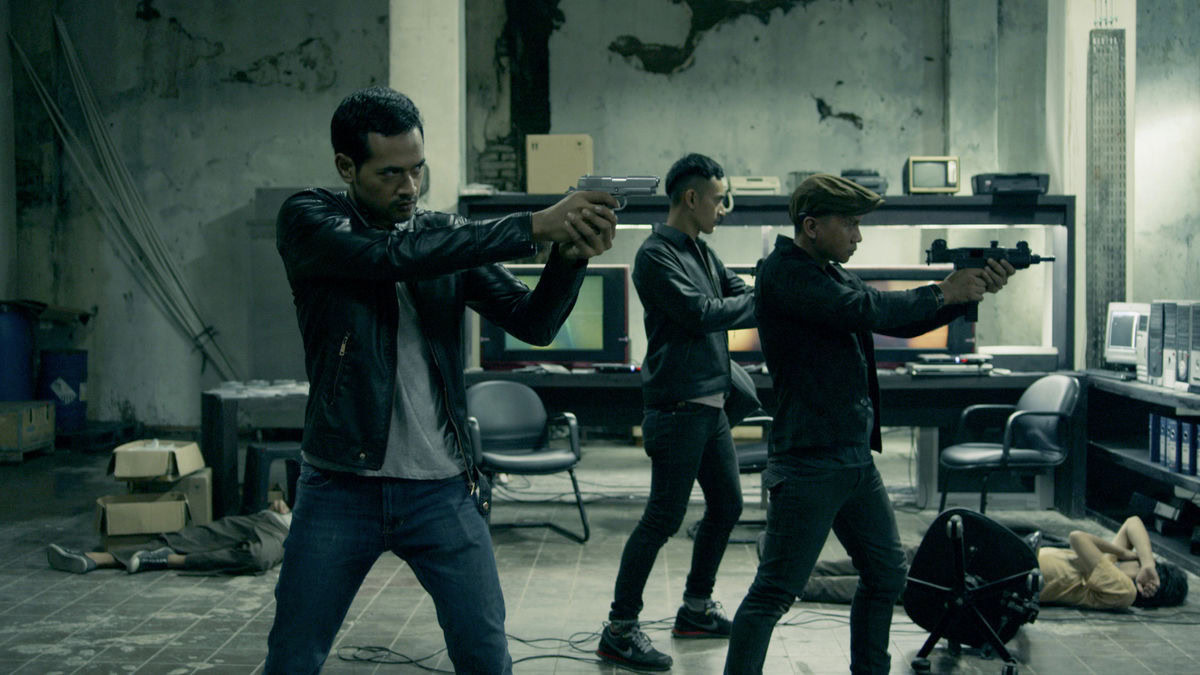 Men aim their guns in The Raid 2