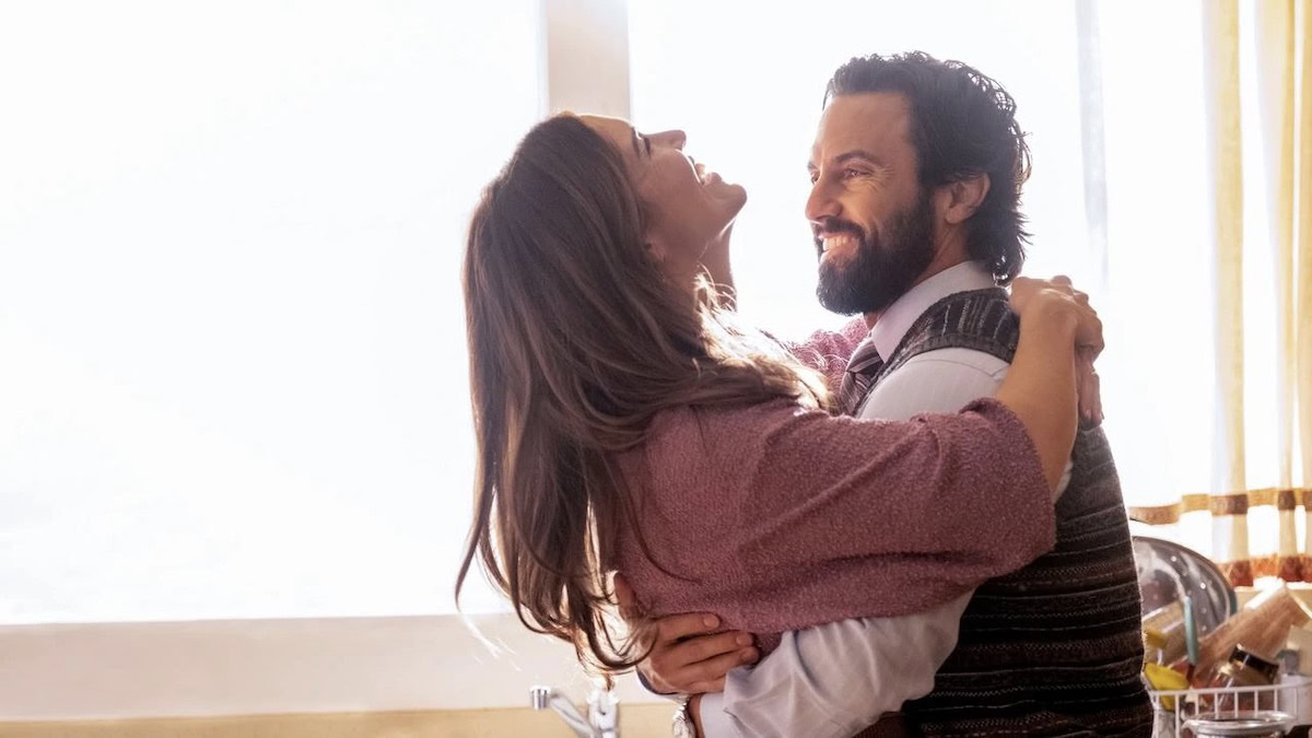 Mandy Moore and Milo Ventimiglia holding each other and dancing in This Is Us - best peacock shows