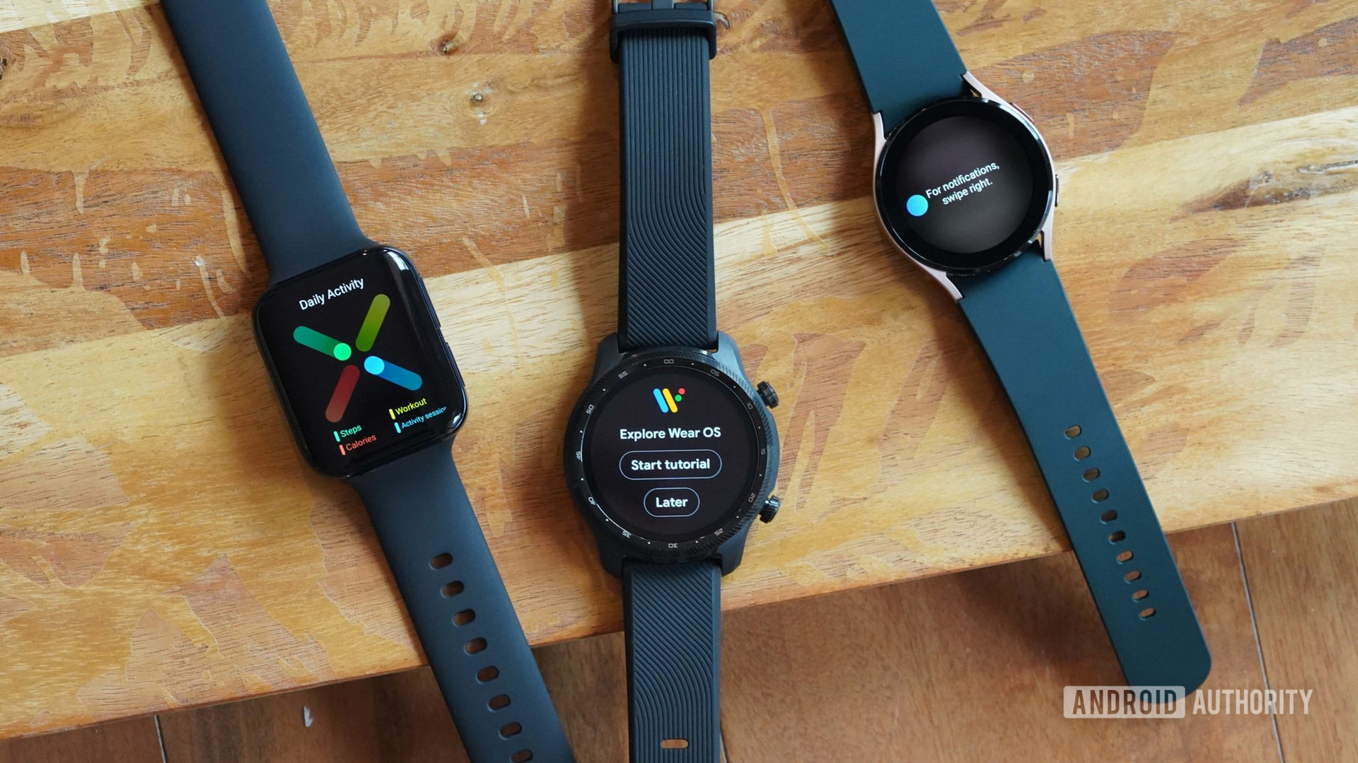 An Oppo Watch, a TicWatch Pro 3 Ultra, and a Galaxy Watch 4 rest on a wooden board, each displaying steps of the Wear OS tutorial.
