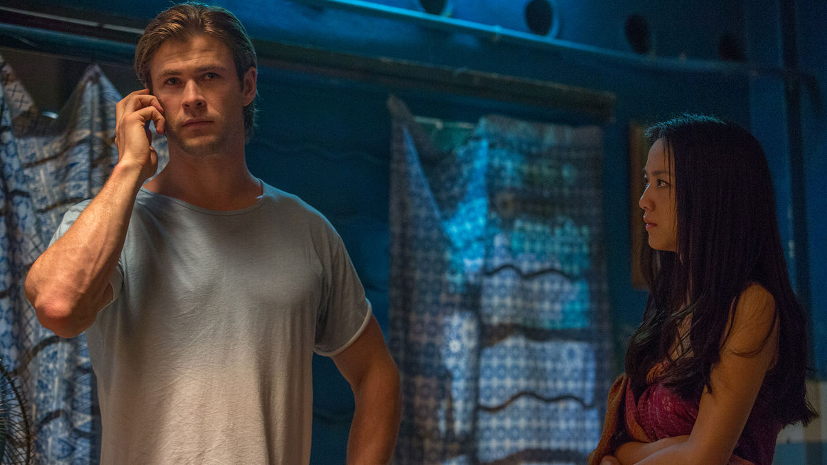 Chris Hemsworth holds a cell phone to his ear, standing next to Tang Wei in Blackhat - best new streaming movies