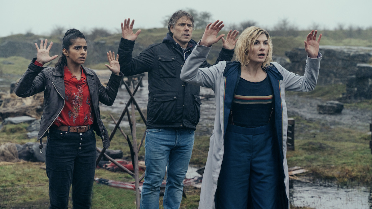 Jodie Whitaker and company have their arms raised in Doctor Who