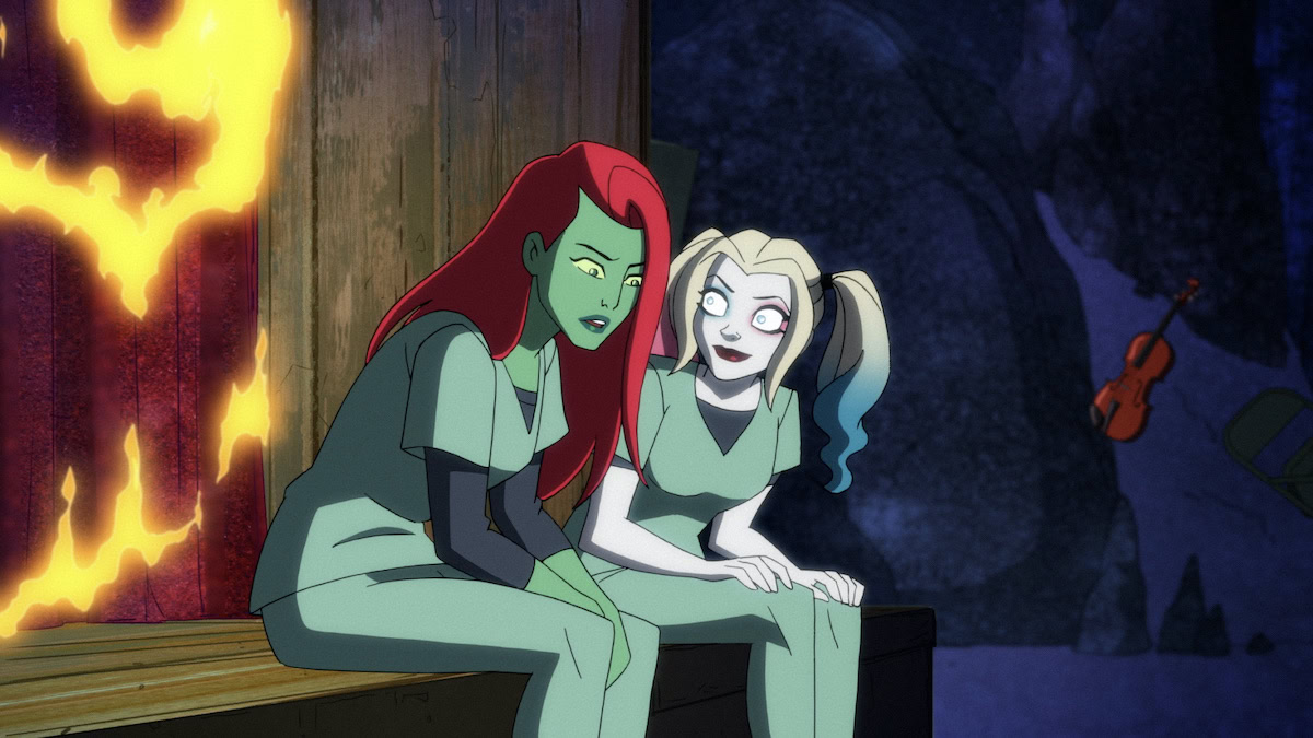 The animated Harley Quinn and Poison Ivy huddle together in Harley Quinn on HBO Max