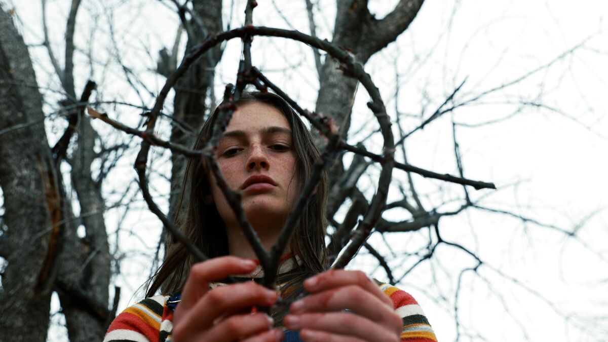 Zelda Adams holds an occult piece of wood in Hellbender - best new streaming movies to watch