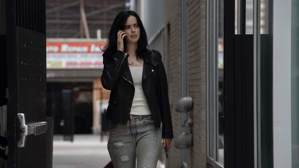 Krysten Ritter walking in an alley in Jessica Jones - shows like Reacher