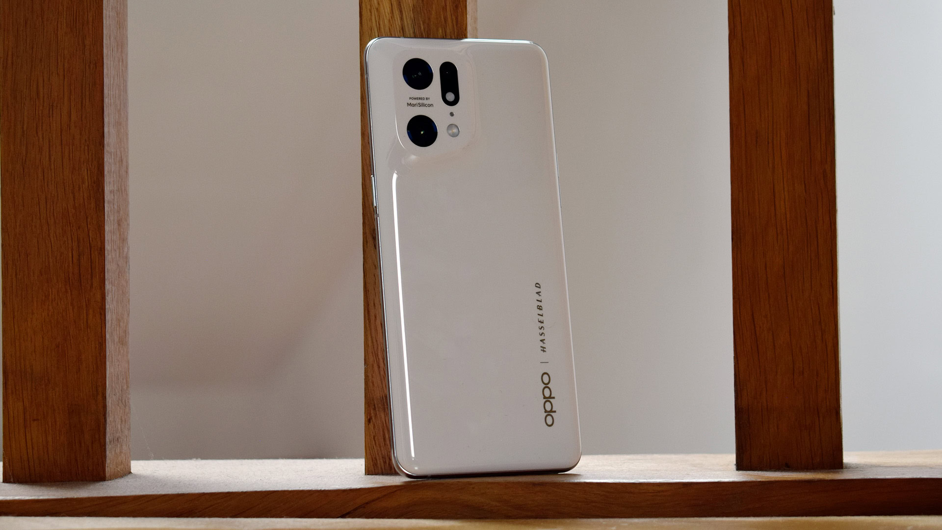 Oppo Find X5 Pro standing on wooden back drop