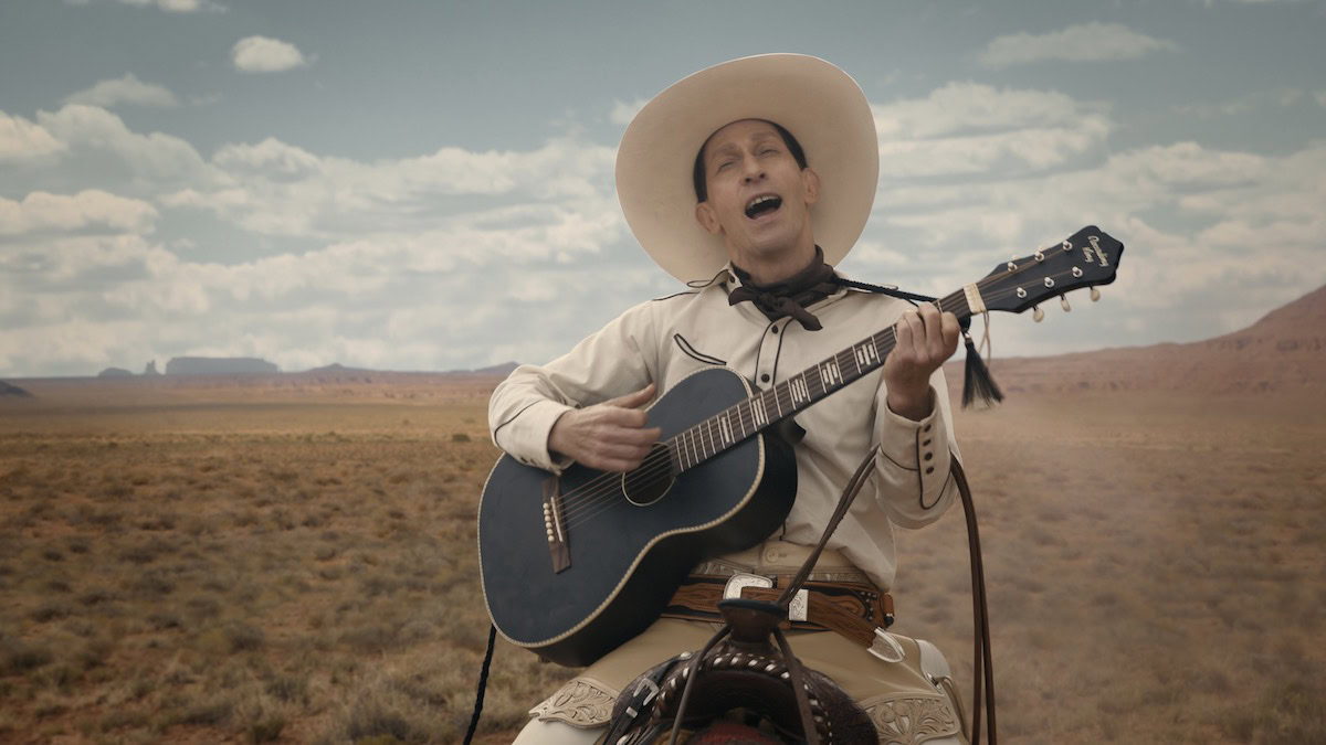 Tim Blake Nelson as Buster Scruggs playing a guitar on horseback in The Ballad of Buster Scruggs - best funny movies on netflix