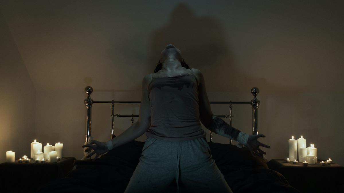 A woman is possessed on a bed in The Last Rite - best new streaming movies to watch