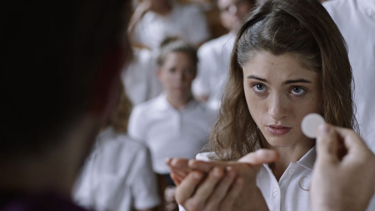 Natalia Dyer takes communion in Yes God Yes - best funny movies on Netflix
