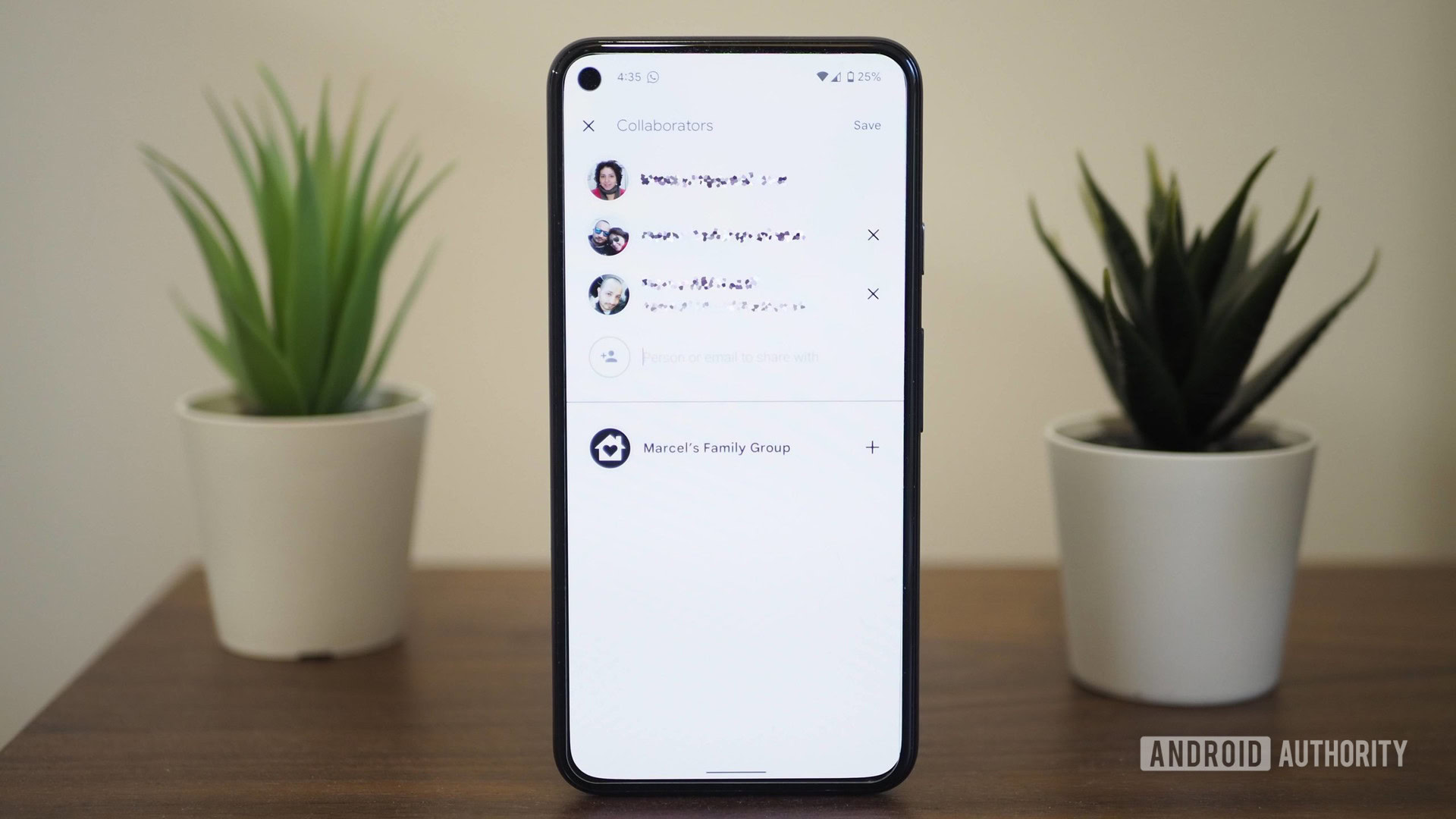 Google Pixel 5 on a table showing Google Keep note sharing with family account