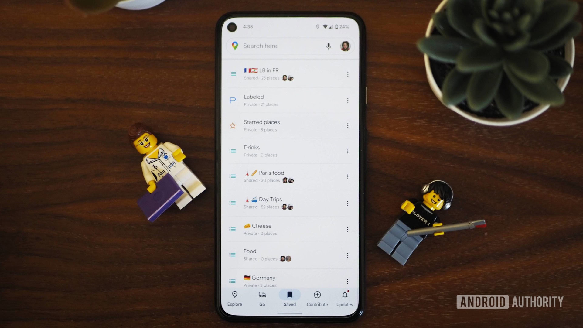 Google Pixel 5 on a table showing personal and shared Google Maps lists