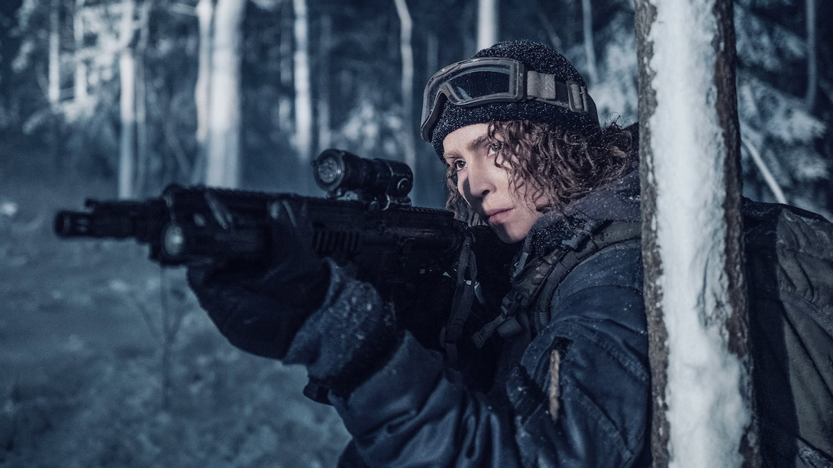 Noomi Rapace aims a rifle in a snowy forest in Black Crab - best new streaming movies