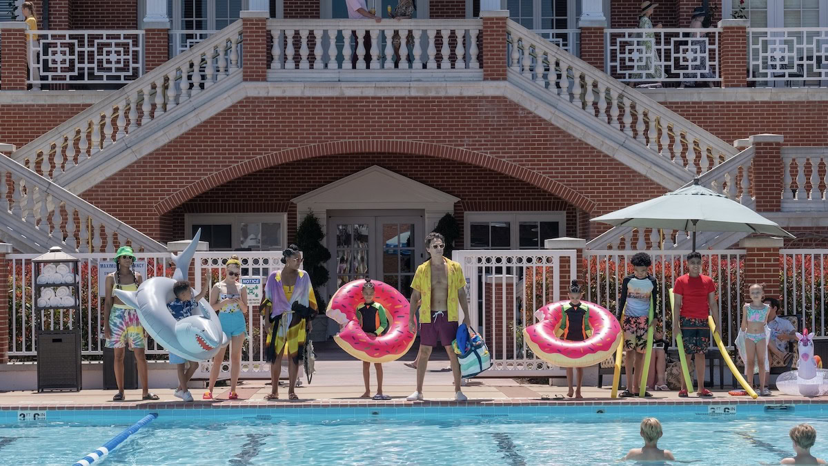 The cast of Cheaper by the Dozen stands along the water at a public pool - new movies to stream